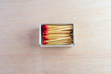 match stick in box  with red head concept energy old vintage on wooden floor background with copy space add text  ( high definition image )