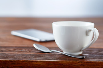 Home office interior in loft space. Workplace with wooden table, office supplies, documents, organizer and laptop.