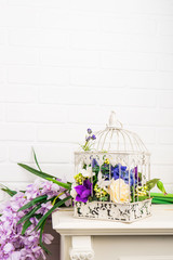 White vintage decorative bird cage with beautiful flowers