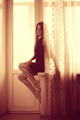 Fototapeta premium young adult woman at the window