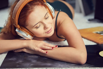 the image of resting sexy woman listening to vinyl
