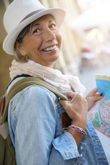 Senior woman traveling in european city, reading map © goodluz