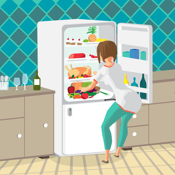 Young woman housewife takes out food from the refrigerator in th