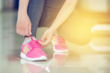 woman runner tying shoelace