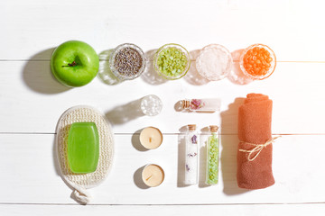 Composition of spa treatment on white wooden table with space for text. Top view. Sun flare
