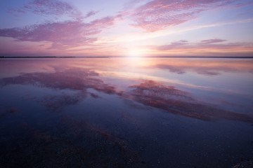 Fototapeta na wymiar Colorful beautiful cloudy sunset over ocean horizon