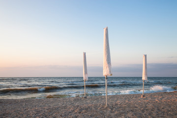 White umbrella on the morning beach