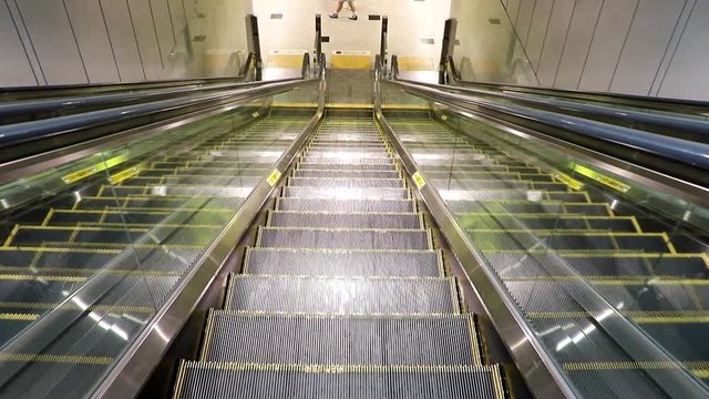 Empty escalator from the metro station. Entrance of the subway on the moving stairs.