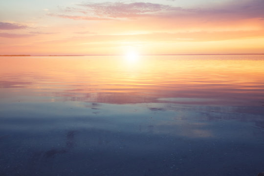 Fototapeta Scenic ocean sunset over the calm water surface