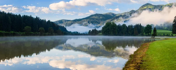 Foto op Canvas Panorama of Alpine mountain summer lake at sunny foggy morning © Nickolay Khoroshkov