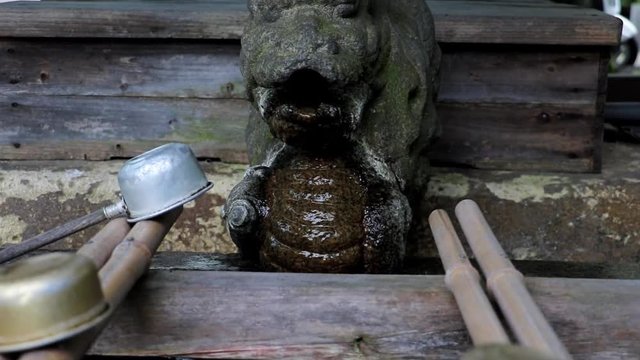 a ladle at the well with a water spout, shrine at Osaka castle area, Japan