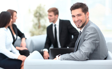 Fototapeta premium businessman sitting in an office on the background of business team.