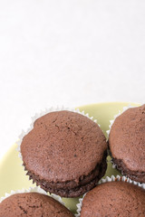 Flat lay above chocolate cup cakes on the white marble background with copy space
