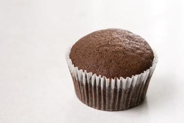 Chocolate cup cake on the white marble background with copy space
