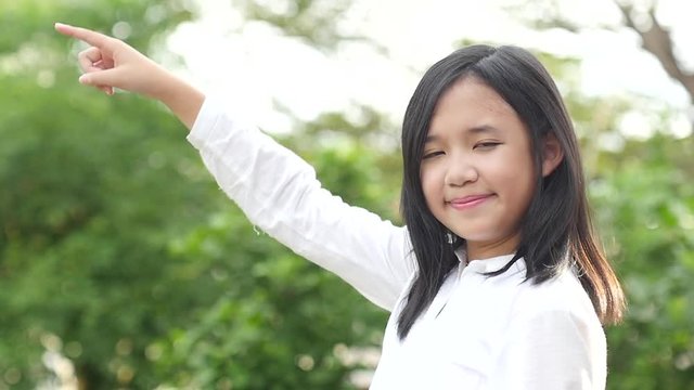 Close up of asian girl bored on nature background slow motion 