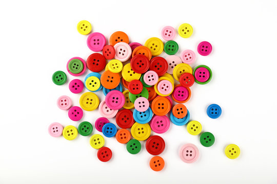 Mix of round colorful sewing buttons on white