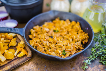 Chanterelle mushrooms on a frying pan.