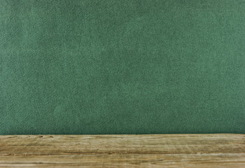 Old wooden deck table with green grunge background