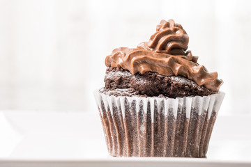 Chocolate cup cake with ganache chocolate cream with white background
