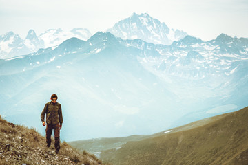 Fototapeta premium Man hiking Travel Lifestyle concept Caucasus mountains landscape on background adventure vacations outdoor trail running sport