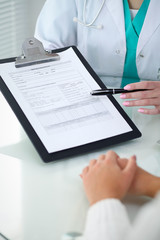 Fototapeta premium Doctor and patient, close-up of hands. Physician talking about medical examination results. Medicine, healthcare and helping concept