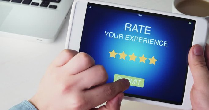 Man gives five star rating using digital tablet application