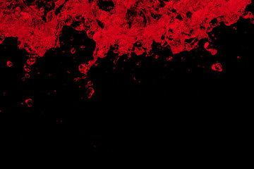 red water splash isolated on black background