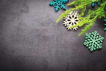 Background christmas decoration twig and wooden stars on back slate.