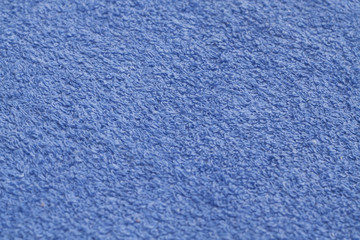 Blue color towel surface close-up with blur effect.