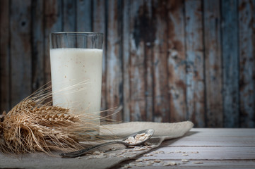 Fresh dairy products and wheat on rustic wooden background. Organic farming dairy concept