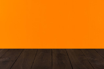 Orange  halloween background with black wooden board, perspective.