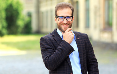 Portrait of a happy man with glasses aged 40 - 45 years.