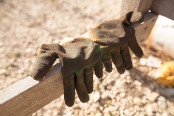 dirty building gloves lie on the construction site