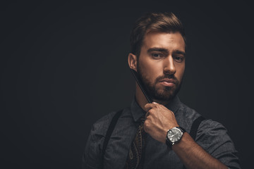 Handsome man combing beard