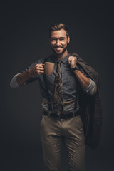 Fototapeta premium Handsome man holding cup of coffee