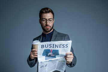 Businessman reading newspaper