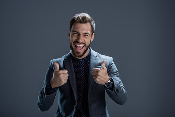 Man in suit showing thumbs up
