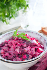 Obraz na płótnie Canvas German traditional salad with beets, apple, egg and herring in a bowl, selective focus