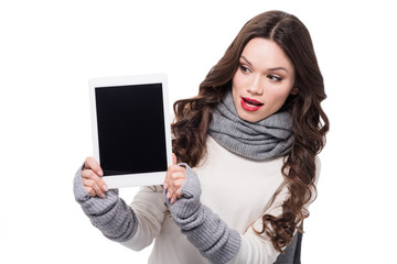 Excited woman showing digital tablet