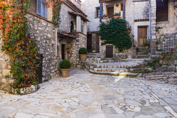 Narrow cobbled streets with flowers in the old village Gourdon, France