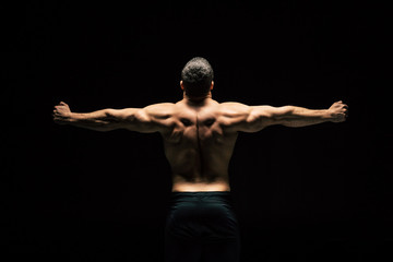 Naklejka na ściany i meble shirtless sportive man showing muscles