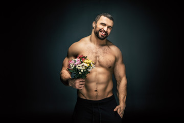 sportive man with bouquet of flowers