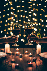 women holding wineglasses on bokeh