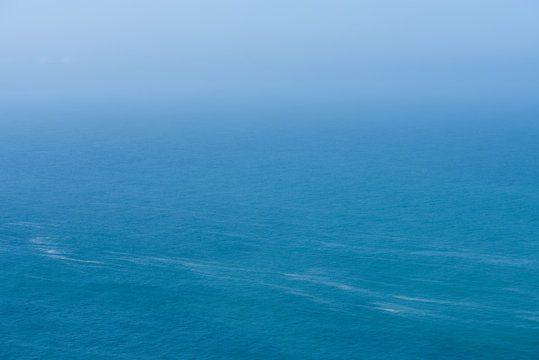 Fototapeta Aerial view of calm infinite ocean and blue sky background