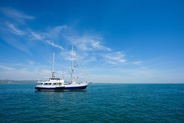 Fototapeta na wymiar White yacht in the sea at summer day