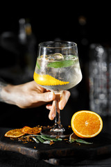 Aperol ice cocktail with tonic and orange on dark background