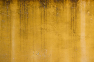 Old weathered yellow painted stucco wall texture