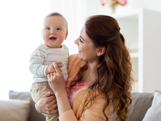 happy young mother with little baby at home