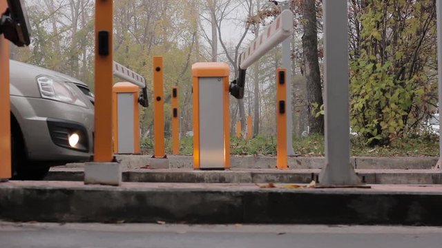 Automatic road barrier gate lifting gate opens and passes car