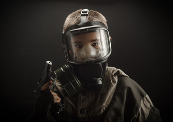  the photo of a boy in a gas mask on grey background